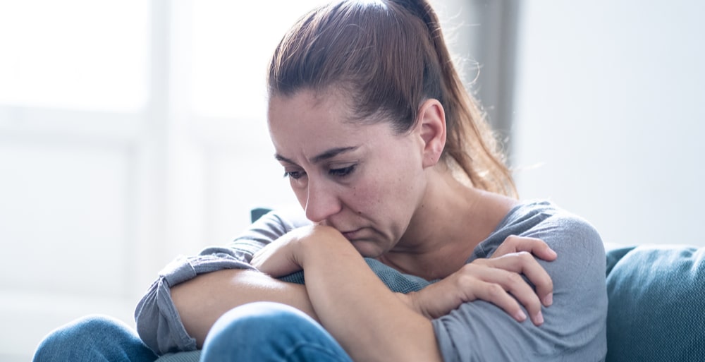 Integrated Treatment North Jersey Recovery Center - A woman is sitting at home depressed, which can lead to her turning toward substance abuse and addiction to cope with the depression. Integrated treatment plans can assist with both depression and addiction