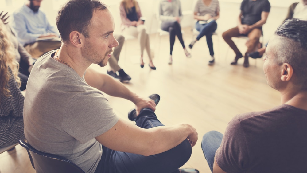 Mental Illness and Addiction: Which Came First? North Jersey Recovery Center - A group of individuals with mental illness and addiction are meeting for a group therapy session led by highly-trained professionals to address treatment plans, advice, and share stories