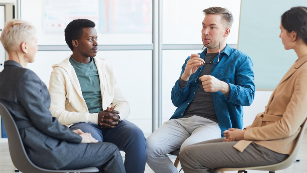 Benzodiazepine Addiction North Jersey Recovery Center - A group of individuals in inpatient rehab for benzo addiction take part in a group therapy session to offer one another support as they move through their treatment plans and find sobriety.