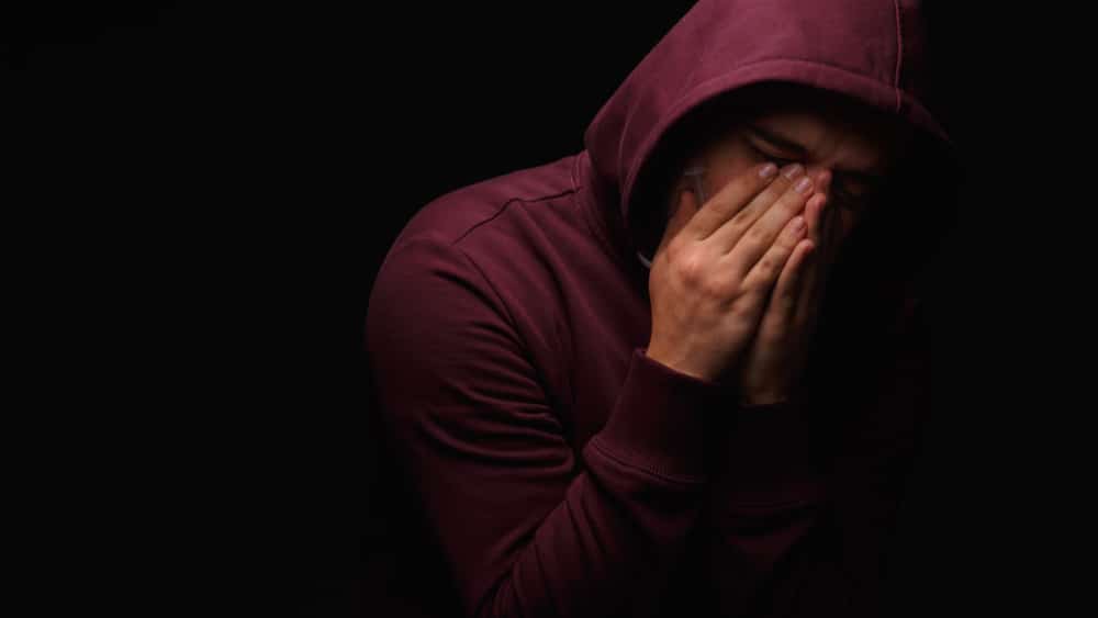 Benzodiazepine Addiction North Jersey Recovery Center - A young man is experiencing intense withdrawal symptoms while trying to fight his benzo addiction without professional help and treatment in a safe and medically-supervised environment.
