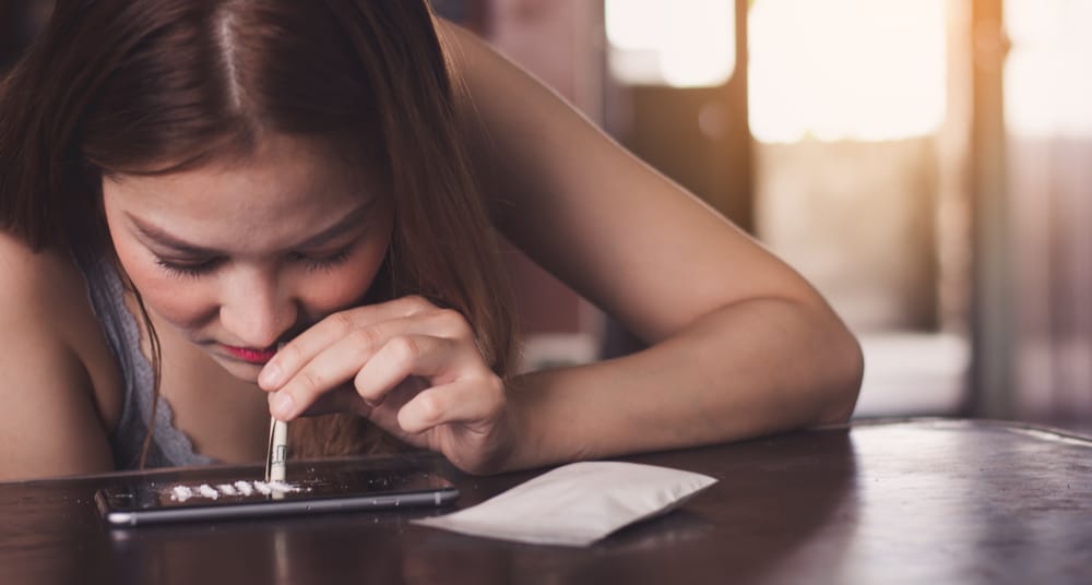 Cocaine Addiction North Jersey Recovery Center - A young female is using cocaine to feel a rush and a high, but she realizes she is struggling with a cocaine addiction and may need to enter a cocaine rehab to start her recovery process -- leading to a sober and healthy life.