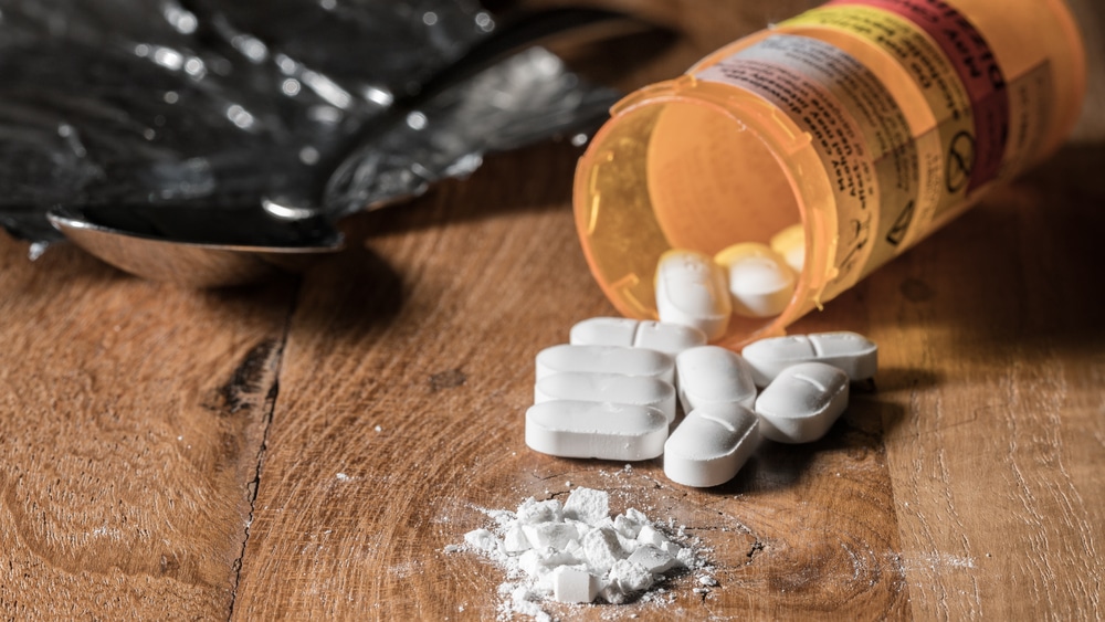 Snorting Oxycodone – Opioid Dependence - North Jersey Recovery Center - a pile of crushed oxy pills sits next to a bottle on its side with pills spilled out.