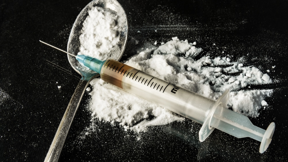 Speedball Abuse and Recovery - North Jersey Recovery Center - A needle with heroin sits on top of a small pile of cocaine used to make a speedball to inject.