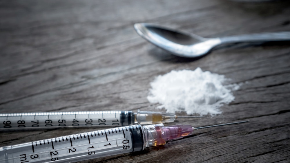 Speedball Abuse and Recovery - North Jersey Recovery Center - Cocaine and needled with heroin wich are used to make speedballs sit next to a spoon.