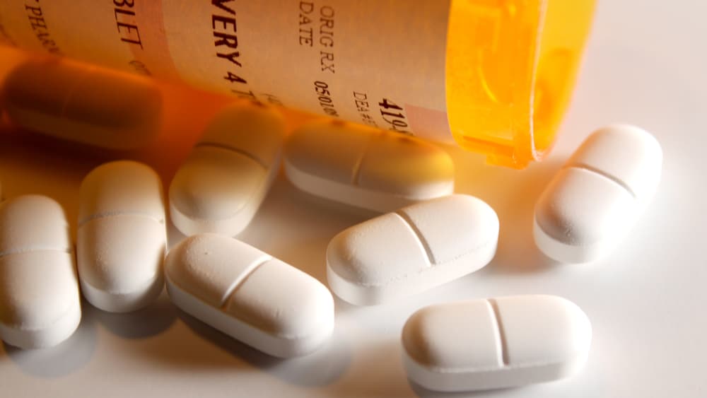 Vicodin Addiction, Abuse, and Treatment - North Jersey Recovery Center  - Several pills of Vicodin lay next to a prescription pill bottle.