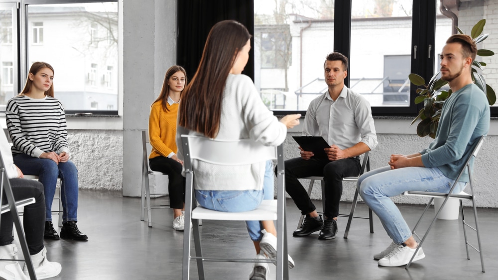 Adderall Addiction and Abuse North Jersey Recovery Center - A group of individuals in residential rehab for Adderall addiction are participating in a group therapy session to offer support to one another as they continue down their journeys to recovery and long-term sobriety.