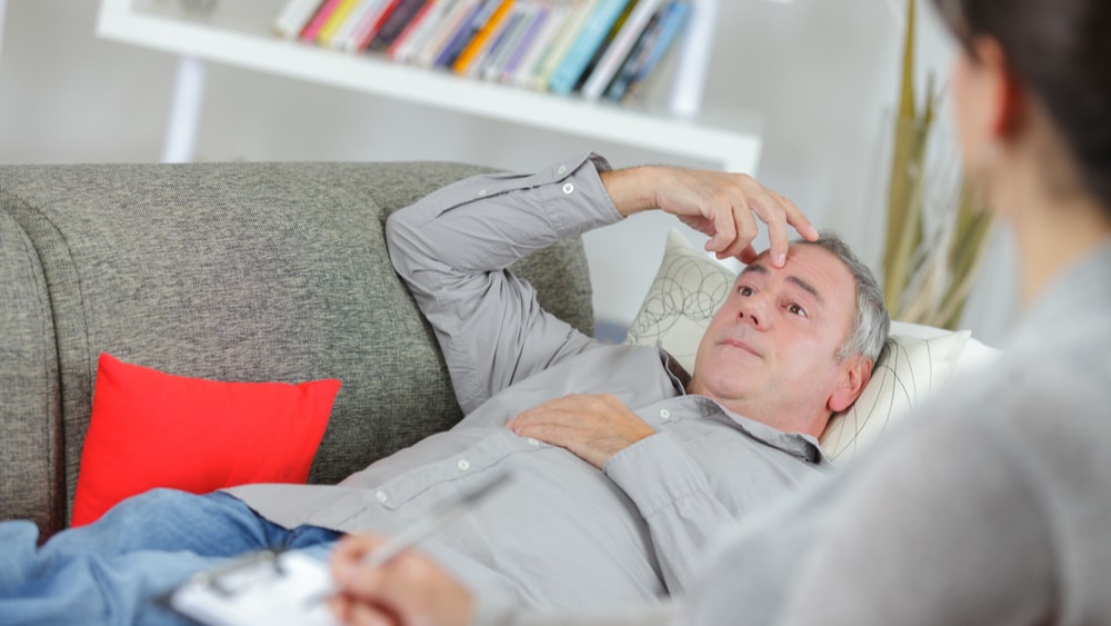 How Long Alcohol is in Your System North Jersey Recovery Center - A man is ready to seek professional treatment for his alcoholism and is sitting with an addiction specialist to determine an appropriate treatment plan as she goes over how long is alcohol in your system, his level of addiction, and any underlying mental conditions.