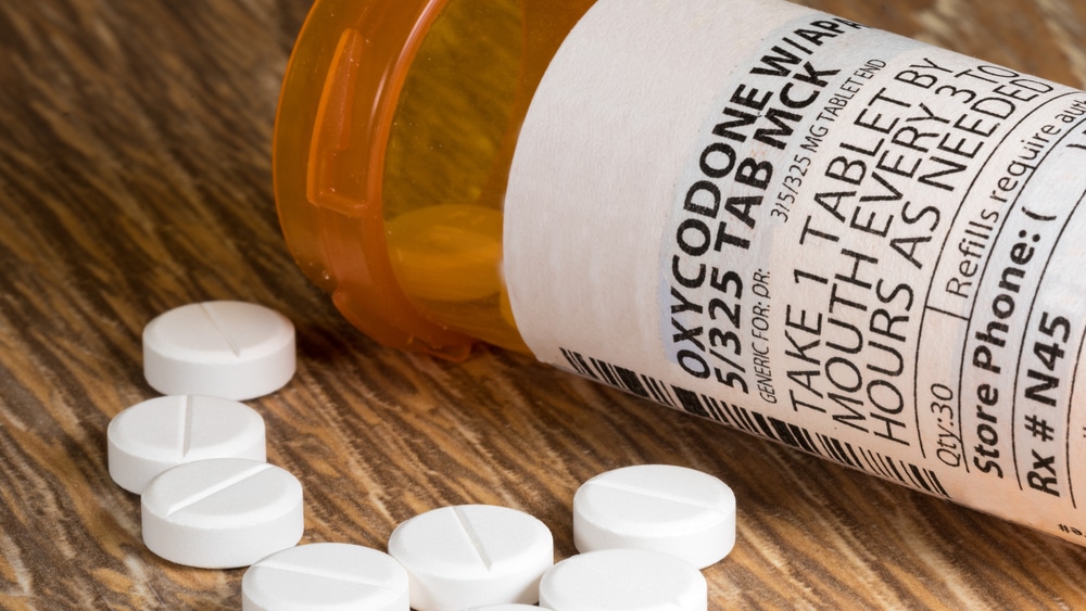 Oxycodone Symptoms and Warning Signs North Jersey Recovery Center - An image of an Oxycodone bottle spilled over, which is a highly addictive pain killer that can often lead to an Oxycodone addiction.