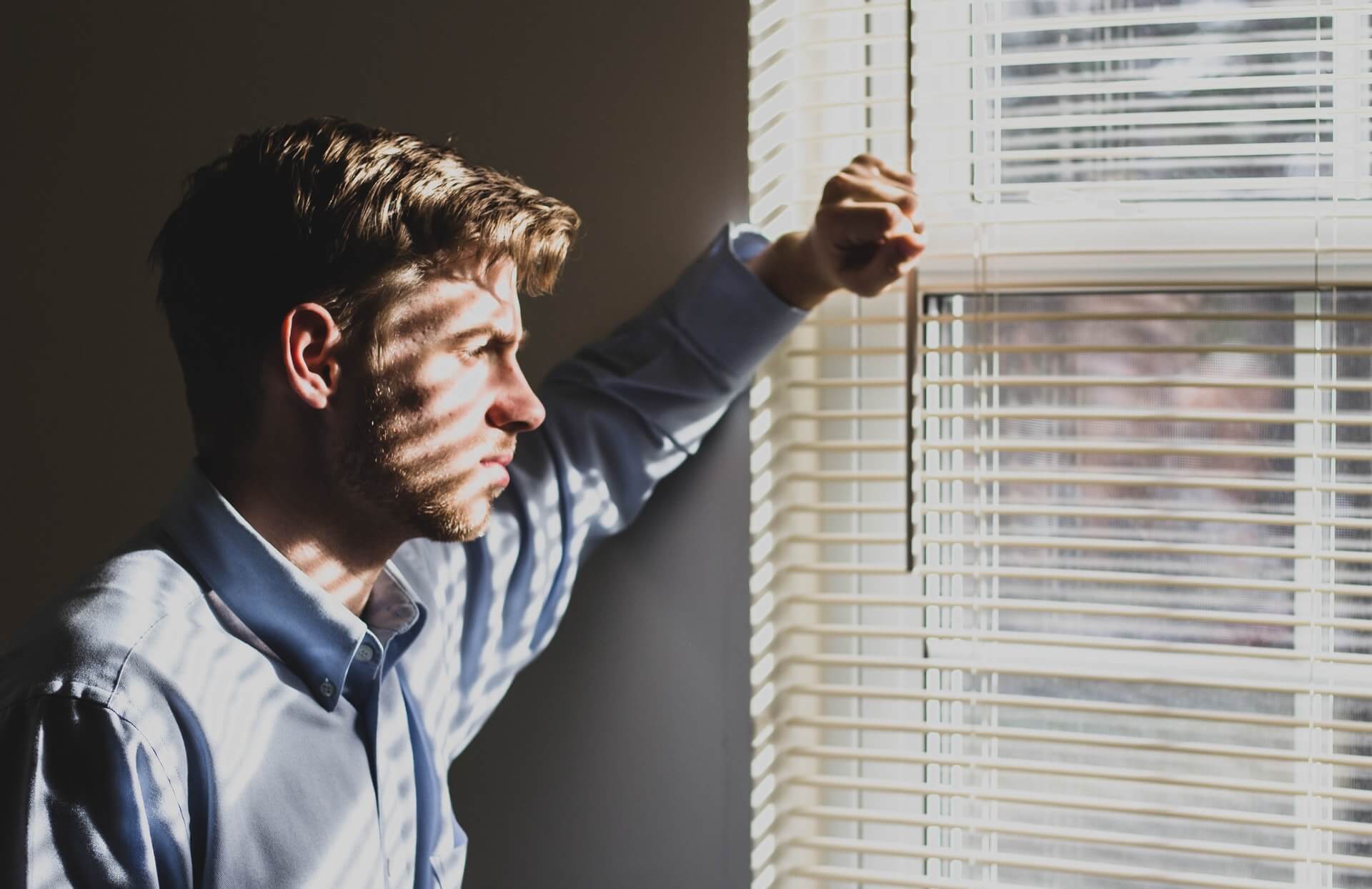 Man deep in thought, looking out window