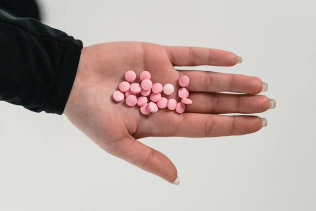 Woman holding many prescription pills - Klonopin Addiction