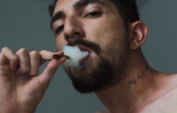 Man smoking marijuana Addicted To Delta 8 THC