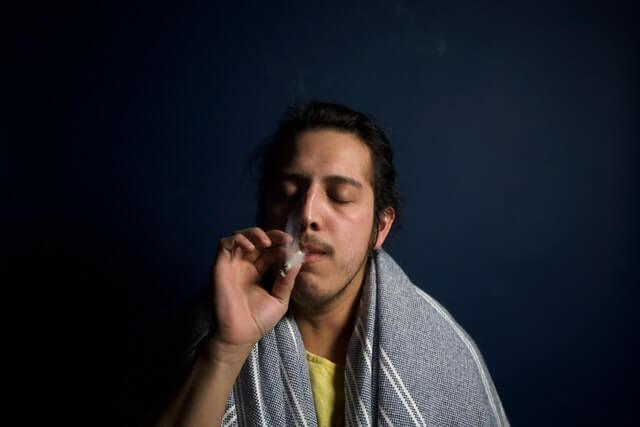 Young man smoking a joint - Medical Marijuana